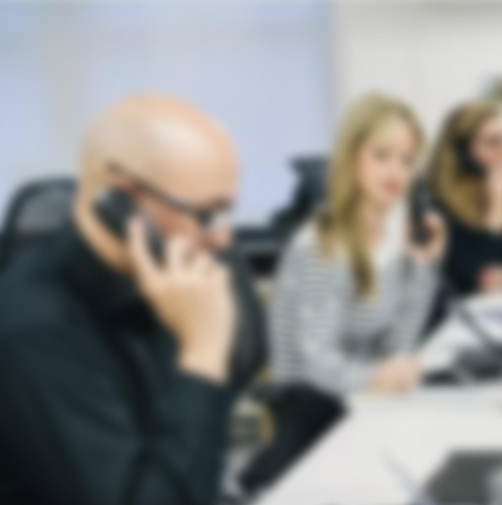 A blurred image of staff in a call centre