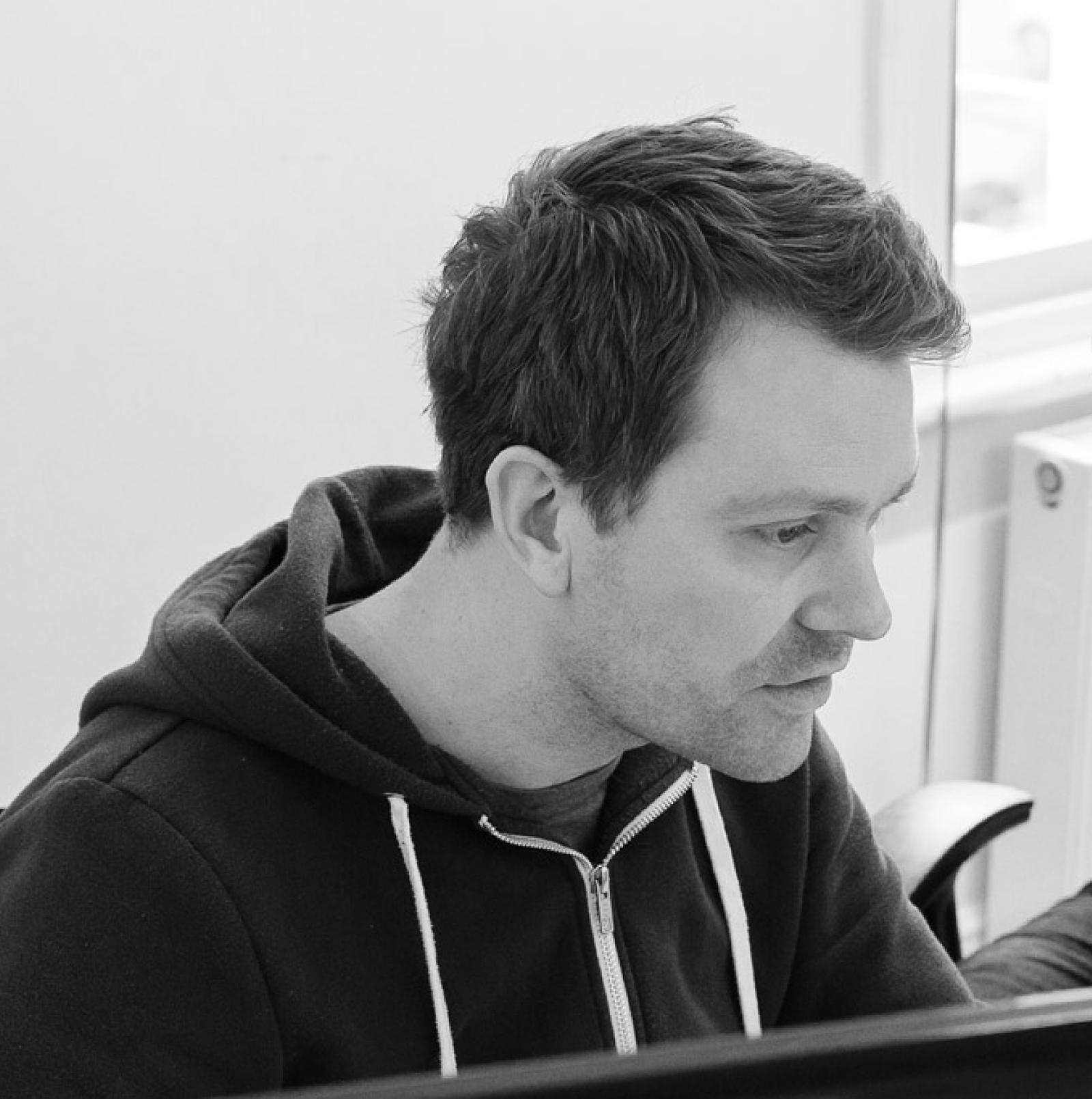 A photo of a man looking at a screen