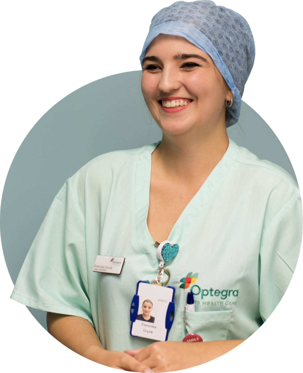 A photo of a staff member in teal coloured gown.