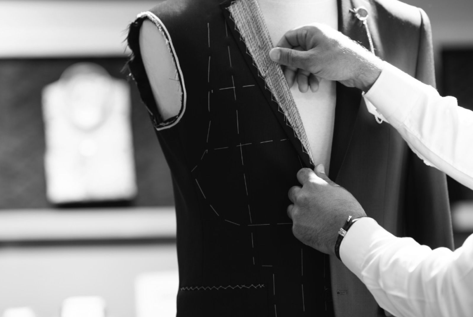 A photo of a suit being created on a mannequin