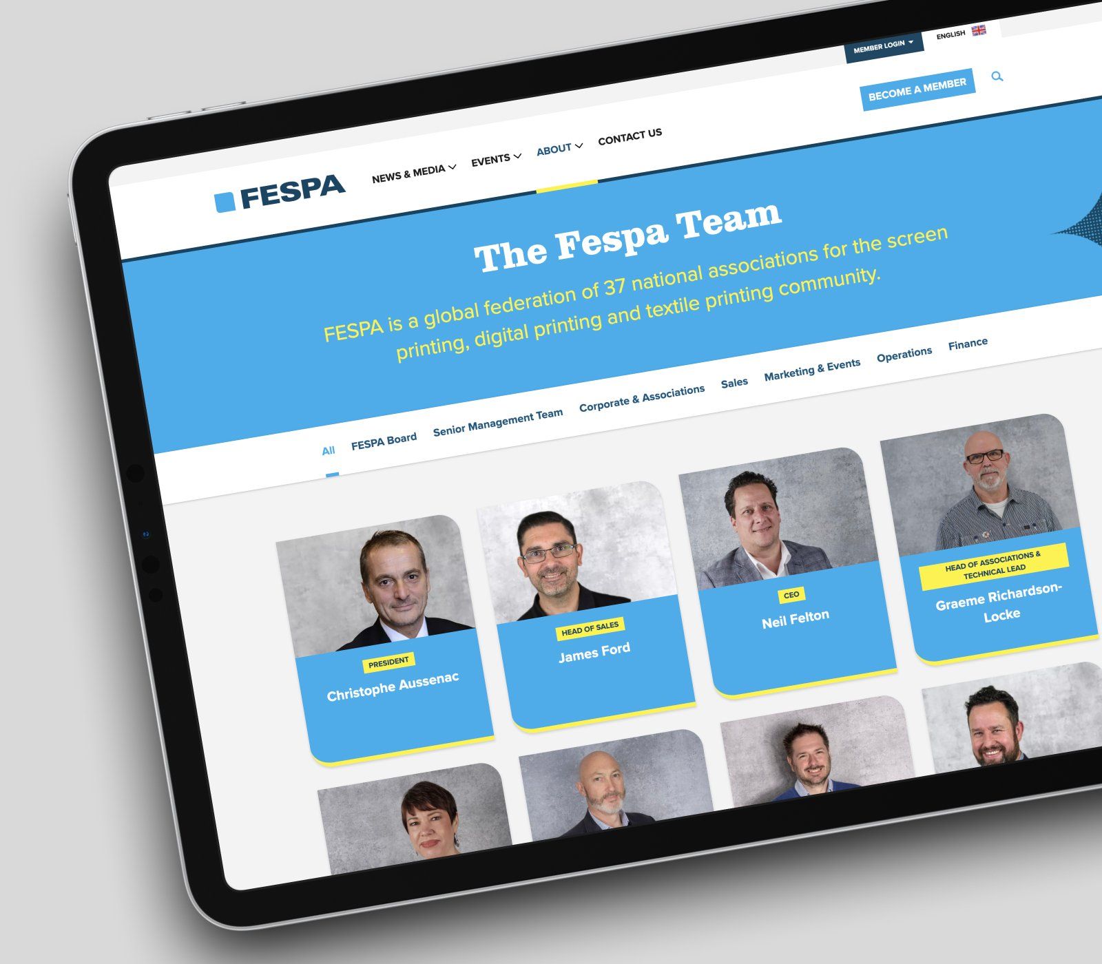 A screen on a tablet of the team page, featuring thumbnails of the FESPA staff in bright blue boxes